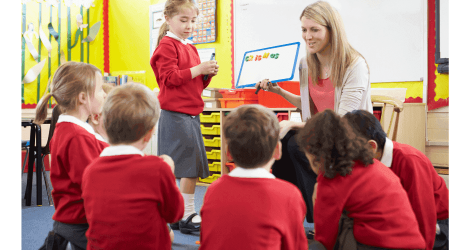 A supply teacher engaging with students in a dynamic classroom setting.